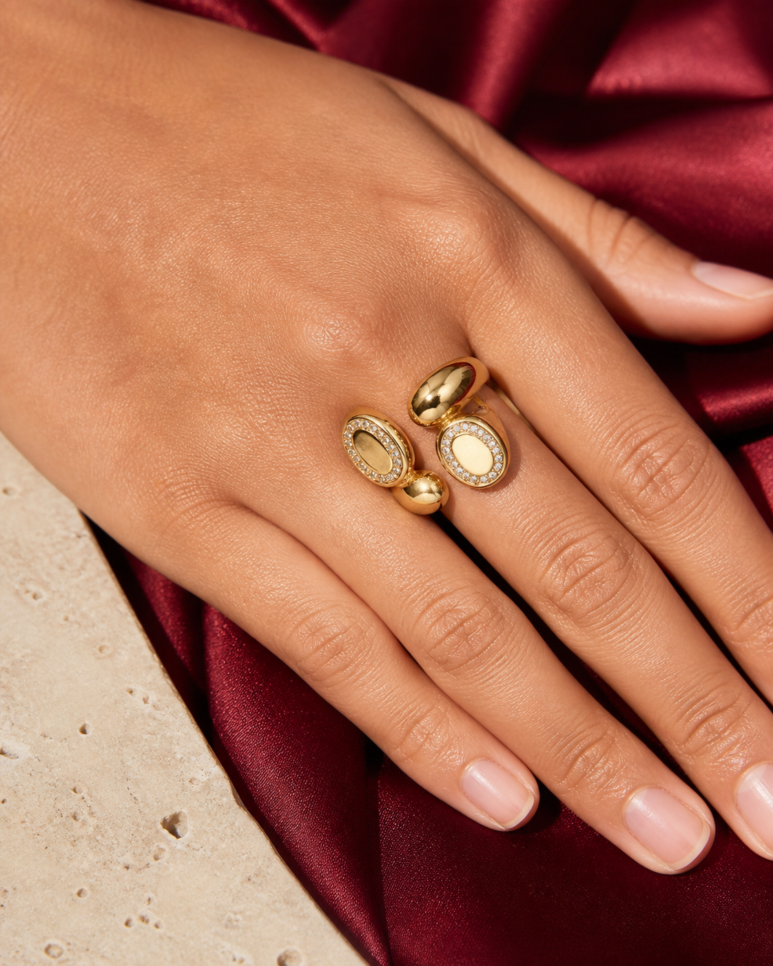 Close-up of a Kessia double oval crystal wrap ring on a hand